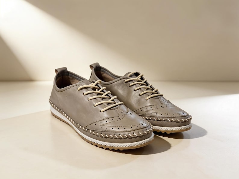 Side view of beige handmade leather flats with flat sole and everyday design