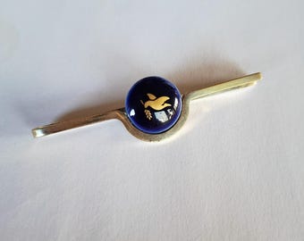 Georg Jensen tie bar, in gold-plated Sterling silver, with a porcelain cabochon.  Produced in collaboration with Royal Copenhagen.