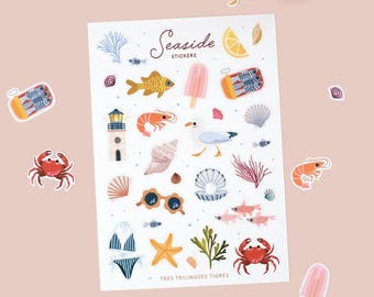 May include: A sheet of "Seaside Stickers" featuring various beach-themed illustrations. Designs include a crab, fish, seashells, a lighthouse, a bikini, and a seagull. The stickers are colorful and whimsical, perfect for scrapbooking or decorating.