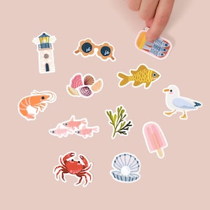 May include: A collection of colorful, illustrated stickers featuring various summer and beach-themed designs. Includes a lighthouse, sunglasses, fish, shrimp, crab, seashell, and a popsicle. The stickers are on a light pink background.