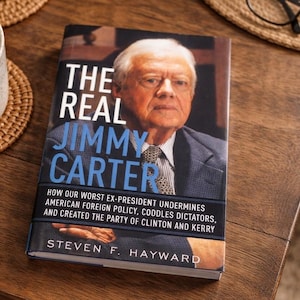 May include: A hardback book titled The Real Jimmy Carter by Steven F. Hayward. The cover features a portrait of Jimmy Carter in a suit and tie, with the subtitle How Our Worst Ex-President Undermines American Foreign Policy, Coddles Dictators.