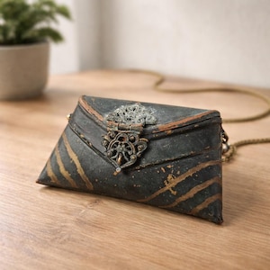 May include: A set of three ceramic mugs with a speckled, matte finish. The mugs are in shades of cream, light gray, and dark gray. Each mug has a simple, minimalist design, perfect for coffee or tea.