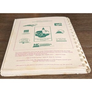 May include: Open book with spiral binding, featuring logos and text related to health and wellness. The cover includes the text "Black Churches United for Better Health a Day" and "Eat 5 A Day".
