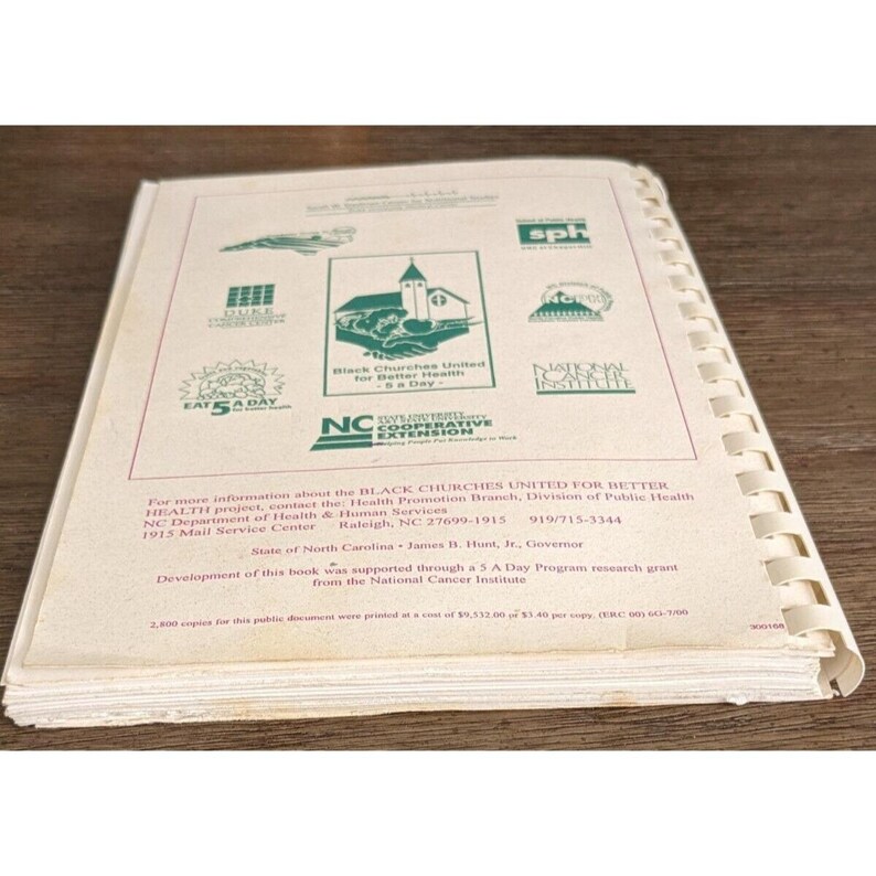 May include: Open book with spiral binding, featuring logos and text related to health and wellness. The cover includes the text "Black Churches United for Better Health a Day" and "Eat 5 A Day".