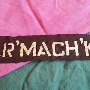 May include: Black fabric patch with white lettering that reads "PAIR'MACH'KAI".