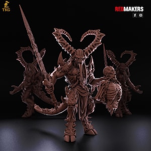 May include: A brown, detailed figurine of a horned demon holding a sword and a severed head. The demon has a long tail and is surrounded by two other similar figures. The logo "REDMAKERS" is in the top right corner.
