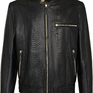 May include: Black leather jacket with a snakeskin texture, featuring a stand-up collar and gold-toned zippers. The jacket has a full-length zipper closure and multiple zippered pockets. A stylish outerwear piece.