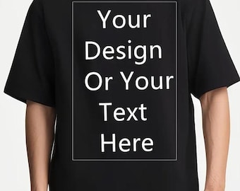 May include: Black t-shirt with the text "Your Design Or Your Text Here" in a white rectangular box. The shirt has short sleeves and a crew neck.