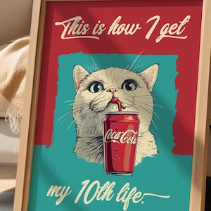 May include: A framed print featuring a cartoon cat drinking from a Coca-Cola can. The cat is light beige with large eyes. The background is teal and red, with the text "This is how I get my 10th life."