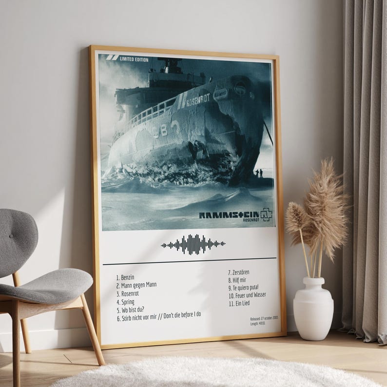 May include: A framed poster featuring a monochrome image of a ship in rough waters. The poster includes the band name "Rammstein" and the album title "Rosenrot". A list of song titles is printed below the image.