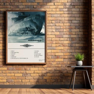 May include: A framed poster featuring a grayscale image of a ship in turbulent waters. The poster includes the band name and a list of song titles. The poster is displayed on a brick wall with a small side table and a potted plant.