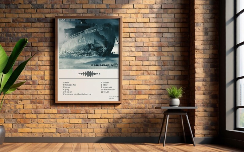 May include: A framed poster featuring a grayscale image of a ship in turbulent waters. The poster includes the band name and a list of song titles. The poster is displayed on a brick wall with a small side table and a potted plant.