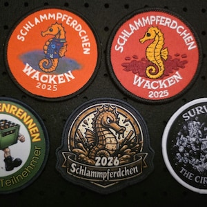 May include: A collection of embroidered patches with various designs. The patches feature seahorses, text, and other graphics. Some patches include the text "Wacken 2025" and "Schlammpferdchen". Other patches include the text "Bierkistenrennen" and "Survived The Circle Pit".