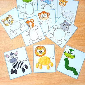 Könnte beinhalten: Eine Sammlung rechteckiger Aktivitätskarten mit Cartoon-Tierköpfen und leeren oder teilweise ausgefüllten Körpern. Die Karten zeigen ein Zebra, einen Löwen, eine Schlange, einen Leoparden, einen Bären, einen Affen, ein Flusspferd, eine Giraffe, einen Elefanten und ein Krokodil, wobei einige Körper mit gelber oder grüner Knete geformt sind.