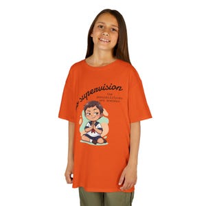 May include: Orange t-shirt featuring the text "no supervision the possibilities are endless" and an illustration of a cartoon character in a seated position. The shirt is a solid orange color.