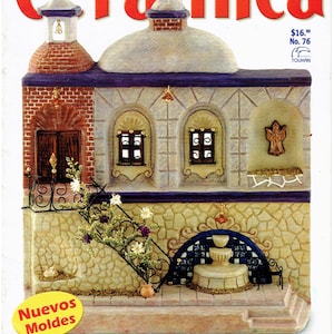 May include: The cover of "Cerámica" magazine showcases a detailed ceramic model of a building with a bell tower, arched windows, and a fountain. The building is made to look like stone and brick, with a blue and white tiled fountain.