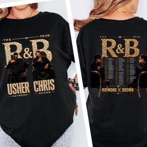 May include: A black t-shirt featuring a graphic print of Usher and Chris Brown. The front displays the text THE R&B TOUR with the names USHER RAYMOND and CHRIS BROWN. The back shows the same artists with a list of tour dates and locations.