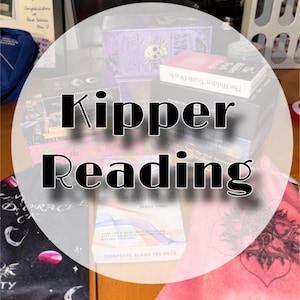 May include: A collection of various oracle card decks in their boxes, including The Hidden Truth Oracle and Insight Oracle Cards, arranged alongside a black fabric pouch with moon motifs and a pink fabric pouch with a dark heart graphic design.