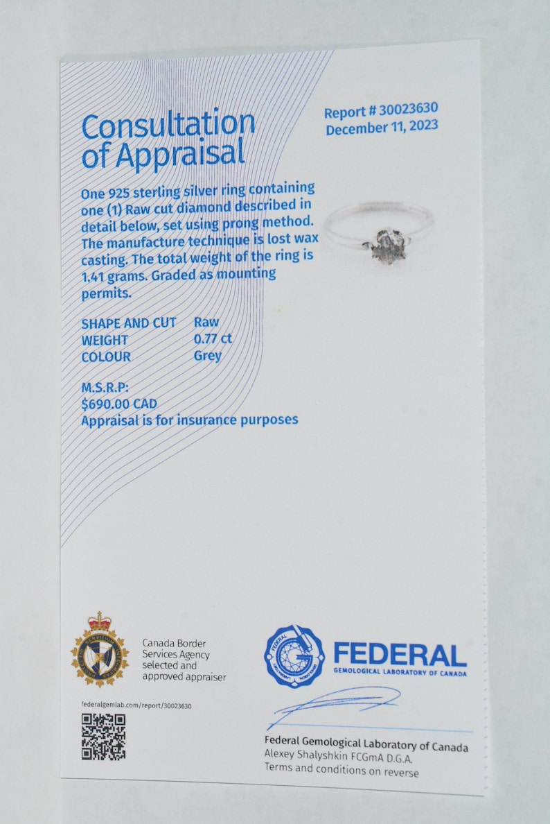 May include: A white appraisal report for a sterling silver ring with a raw cut diamond. The report includes details about the ring, such as the shape, weight, color, and price. The report is from the Federal Gemological Laboratory of Canada.