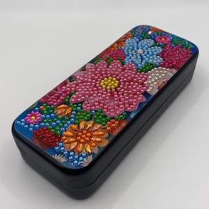 Glasses case decorated with diamond art design, completed and sealed.
