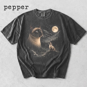 May include: Dark grey t-shirt with a Siamese cat design, a full moon, and a forest. The word "pepper" is printed in white. The shirt has a vintage, washed appearance.