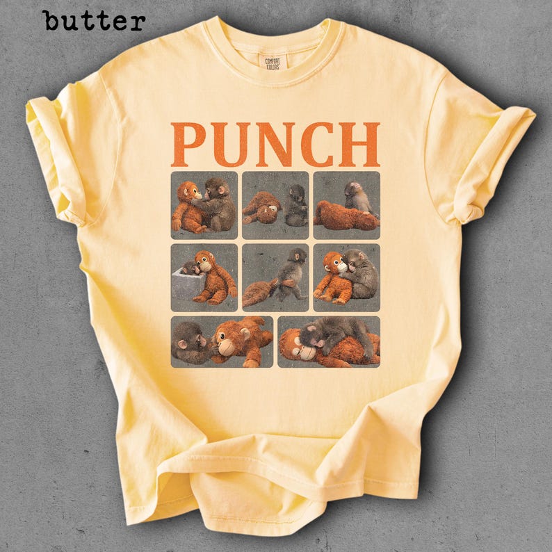 Peut inclure: T-shirt jaune beurre avec le mot "PUNCH" en lettres orange. Le t-shirt pr&eacute;sente une grille de neuf carr&eacute;s, chacun avec une illustration vintage de singes. Le t-shirt a des manches courtes et un col rond.
