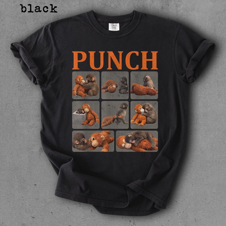 Peut inclure: T-shirt noir avec le mot "PUNCH" en lettres orange. Le t-shirt pr&eacute;sente une grille de neuf carr&eacute;s, chacun avec une illustration diff&eacute;rente de deux singes qui s'embrassent. Le mot "black" est dans le coin sup&eacute;rieur gauche.