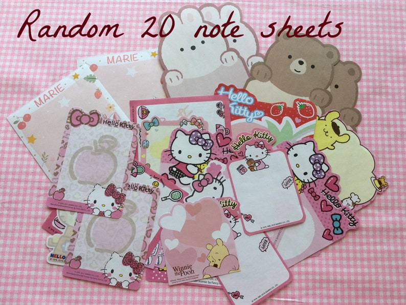 May include: A set of 20 pink and white Hello Kitty themed note sheets. The sheets feature various Hello Kitty characters, including a bear, a bunny, and a bee. The sheets are decorated with hearts, stars, and other cute designs. The text "Hello Kitty" and "Winnie the Pooh" are visible on the sheets.