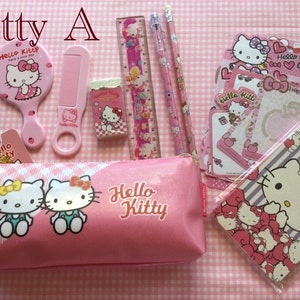 May include: A pink Hello Kitty pencil case with two Hello Kitty characters on the front. The case is filled with Hello Kitty themed school supplies, including a comb, mirror, eraser, ruler, pencils, and stickers.
