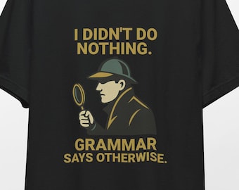 May include: Black t-shirt with a detective graphic and the text "I DIDN'T DO NOTHING. GRAMMAR SAYS OTHERWISE." The design features a detective with a magnifying glass. The shirt is hanging on a wooden hanger.