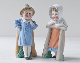 Antique boy and girl bisque china figurines pair, rosy cheeks, leaning on fence, 4", 1800s 19th century Victorian German, English country