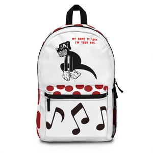 May include: White backpack featuring a black cartoon dog with the text "MY NAME IS LUCY, I'M YOUR DOG." The backpack has a red polka dot pattern and musical notes on the front pocket. It has a black top handle and a black zipper.