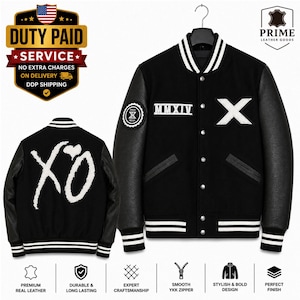 May include: A black varsity jacket with leather sleeves, featuring a white embroidered X on the chest, the Roman numeral MMXIV, and a circular patch on the sleeve. The back displays a large white XO logo with a heart. It has a snap button closure.