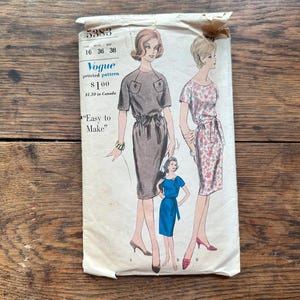 May include: Vintage Vogue sewing pattern number 5383 for a dress. The pattern is for sizes 16, 36, and 38. The pattern shows three women wearing different styles of dresses. The text "Easy to Make" is printed on the pattern.