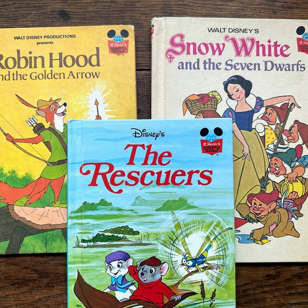 Three Disney hardback books, Snow White and the Seven Dwarves, Robin Hood and the Golden Arrow, the Rescuers, all 1970s