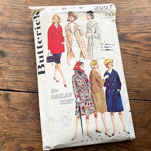 May include: Vintage sewing pattern for a raglan coat. The pattern is for sizes 10-18 and includes four different styles of coats. The pattern is from Butterick and is number 3007.