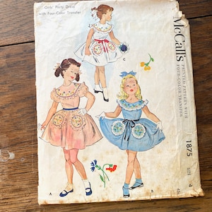 May include: Vintage McCall's sewing pattern for a girl's party dress. The pattern includes a four-color transfer and is size 4. The pattern shows three different styles of dresses, one with a pink skirt, one with a blue skirt, and one with a white skirt.
