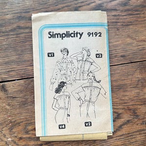 May include: Simplicity sewing pattern number 9192 for a blouse with four different variations. The pattern shows four women wearing different versions of the blouse.