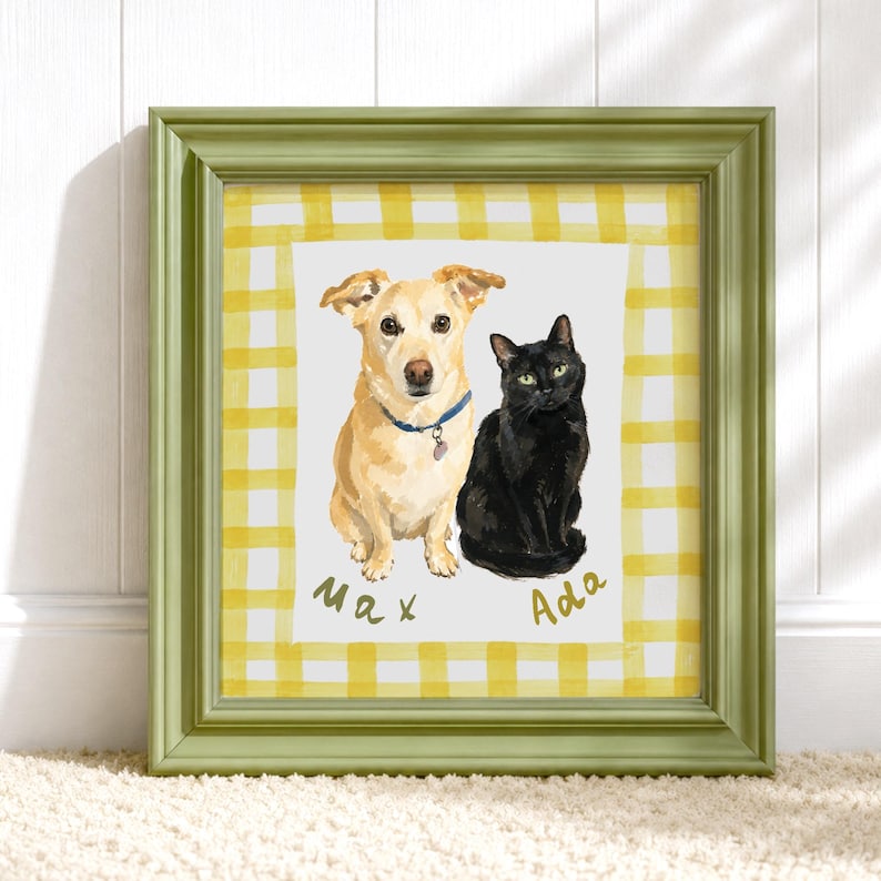 May include: A square framed print featuring a watercolor illustration of a tan dog wearing a blue collar and a black cat. The background has a yellow and white gingham pattern. The names Max and Ada are written in gold script below the animals.