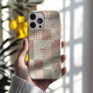 Pode incluir: Capa de telefone com um design de patchwork em tons de rosa, branco e verde. O design apresenta xadrez vichy, estampas florais e laços. Projetado para um smartphone.
