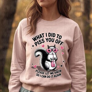 Pink sweatshirt with sassy squirrel attitude design holding pink drink, Galentines funny sweatshirt