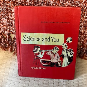 May include: A vintage red book titled "Science and You" with illustrations of children and scientific instruments. The book cover also includes the text "Science Today and Tomorrow" and the author's name, Craig Bryan.