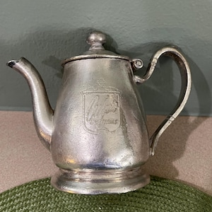 May include: A set of three ceramic mugs with a speckled, matte finish. Each mug features a different color: light blue, cream, and gray. The mugs have a simple, modern design and a comfortable handle.