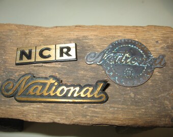 National Cash Register Co NCR set of three Emblems 2 National and 1 NCR Dayton Ohio
