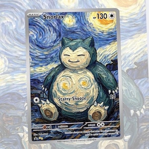 May include: A Snorlax Pok&eacute;mon trading card with a unique design. The card features a blue and cream-colored Snorlax character in a starry night art style. The card has the text "Starry Snooze" and "Snorlax".