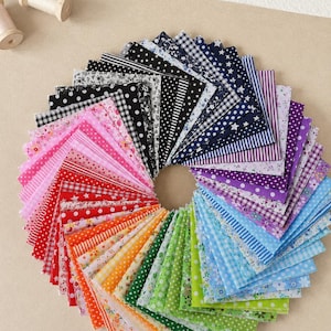 May include: A collection of square fabric swatches arranged in a circular fan pattern. The fabric pieces feature a variety of patterns including polka dots, stripes, gingham, stars, and floral prints in a full spectrum of colors from black to purple.