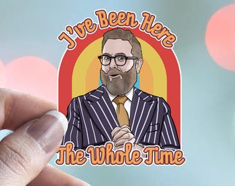 May include: A die-cut sticker featuring a cartoon illustration of a bearded person wearing glasses, a white shirt, a tan tie, and a dark blue pinstriped blazer. The text "I've Been Here The Whole Time" arches over a colorful rainbow background.