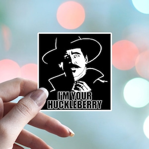 May include: Black and white sticker featuring a man in a hat and coat with the text "I'm your Huckleberry".