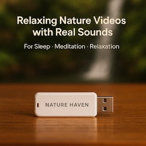 May include: A white USB drive with the text "NATURE HAVEN" is displayed on a wooden surface. The image has text that reads "Relaxing Nature Videos with Real Sounds" and "For Sleep · Meditation · Relaxation". The background is a blurred image of a waterfall.