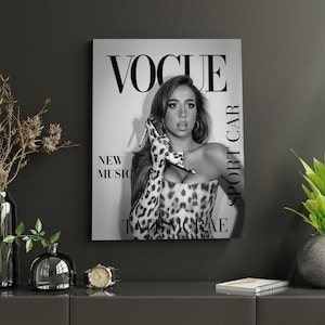 May include: A white ceramic mug with a black handle and the text "But First, Coffee" in a black, bold font. The mug is sitting on a wooden surface. The mug is approximately 4 inches tall.